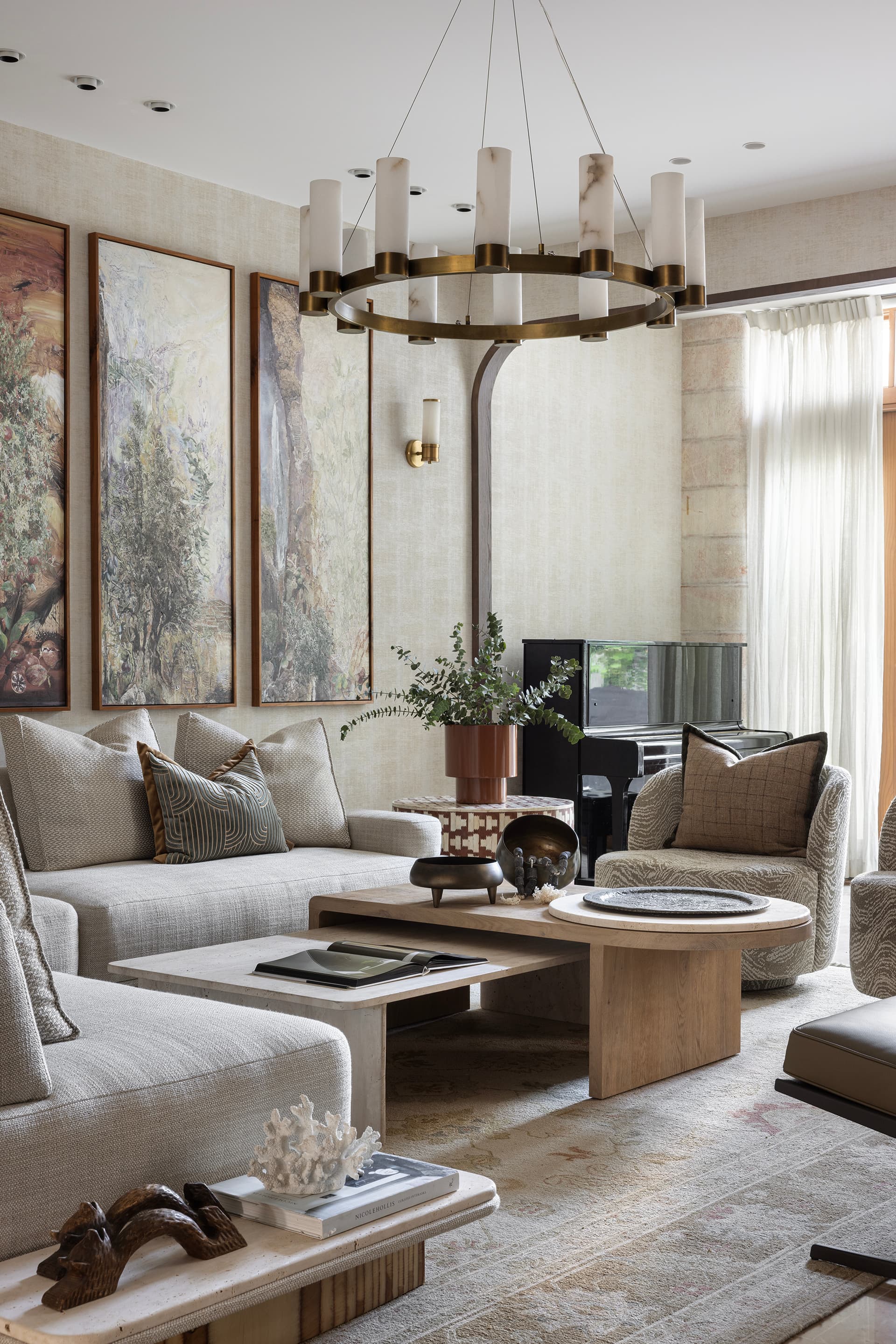 Luxury living room with dark wood bookshelves and polished stone floors by Wolff Construction