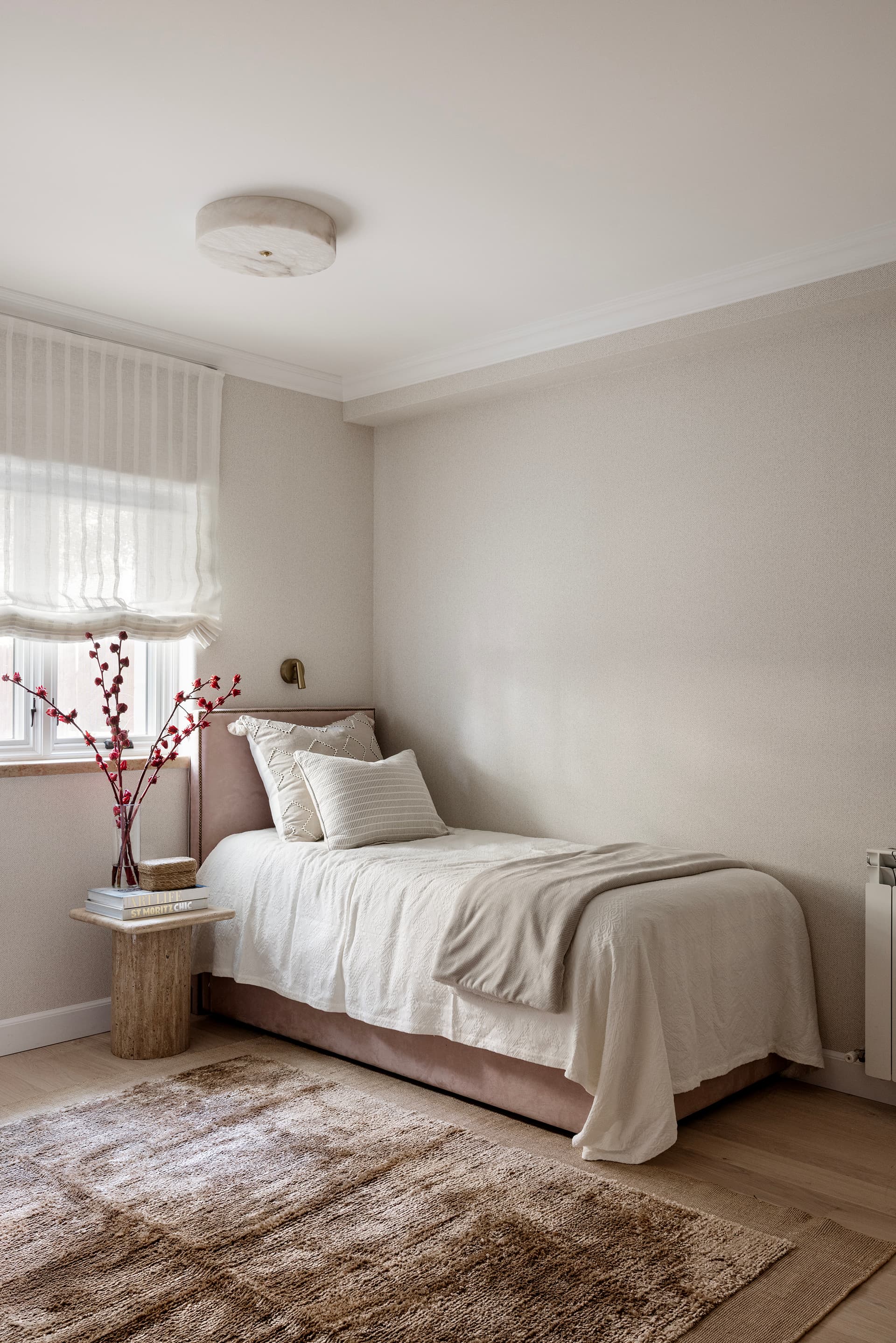 Guest bedroom with layered bedding and soft light
