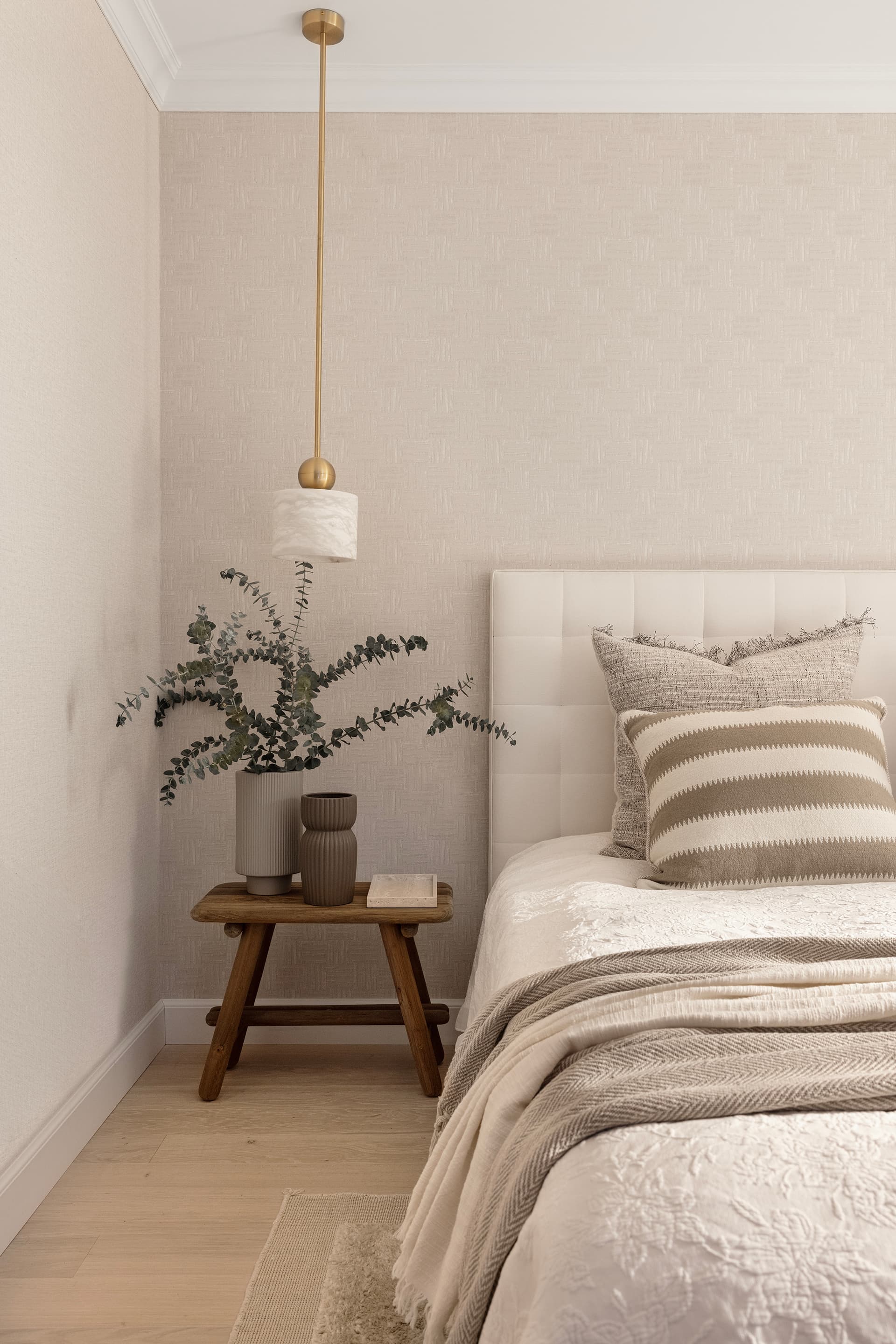 Bedroom detail with stone and ceramics on bedside
