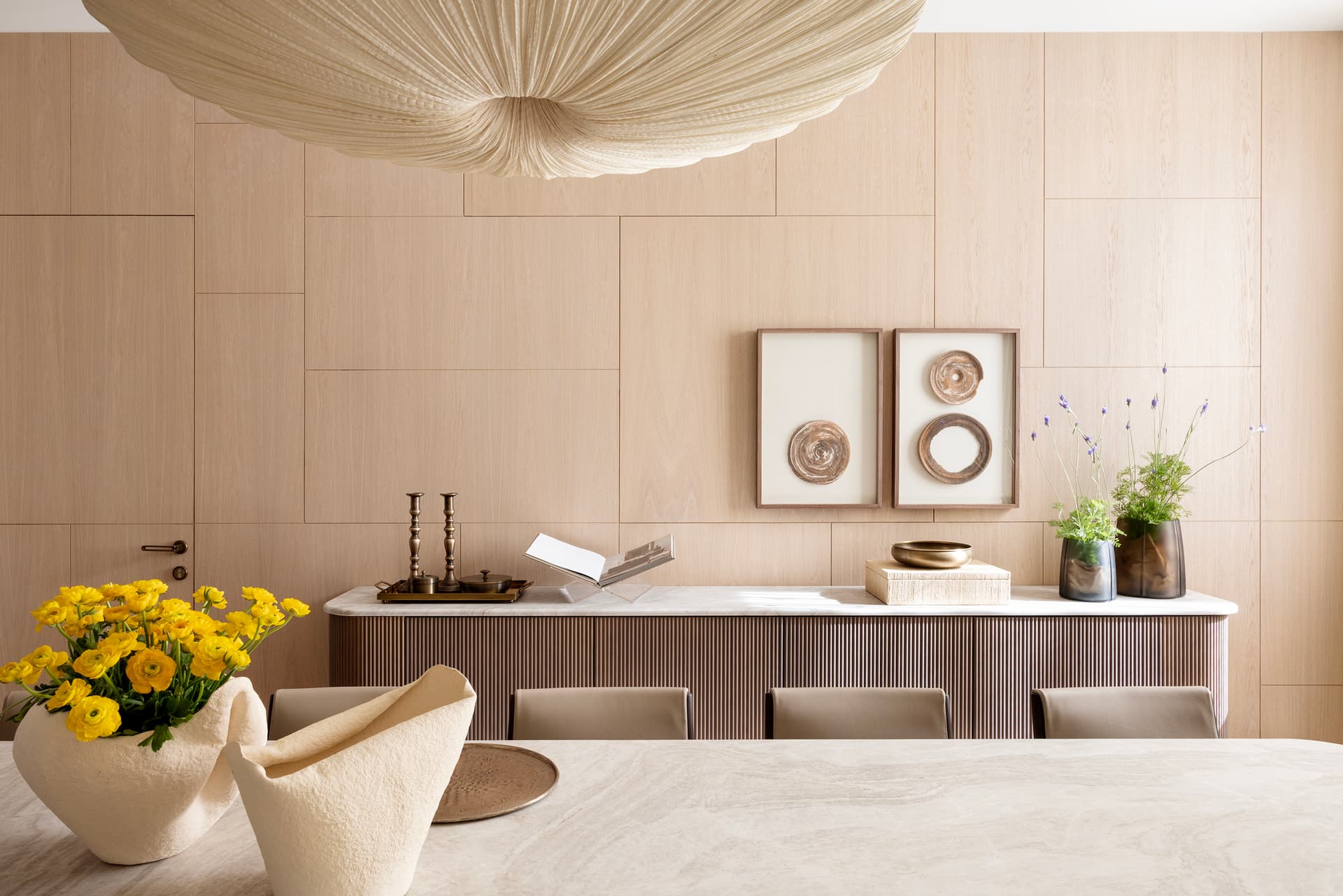 Dining room detail with ranunculus and fluted sideboard