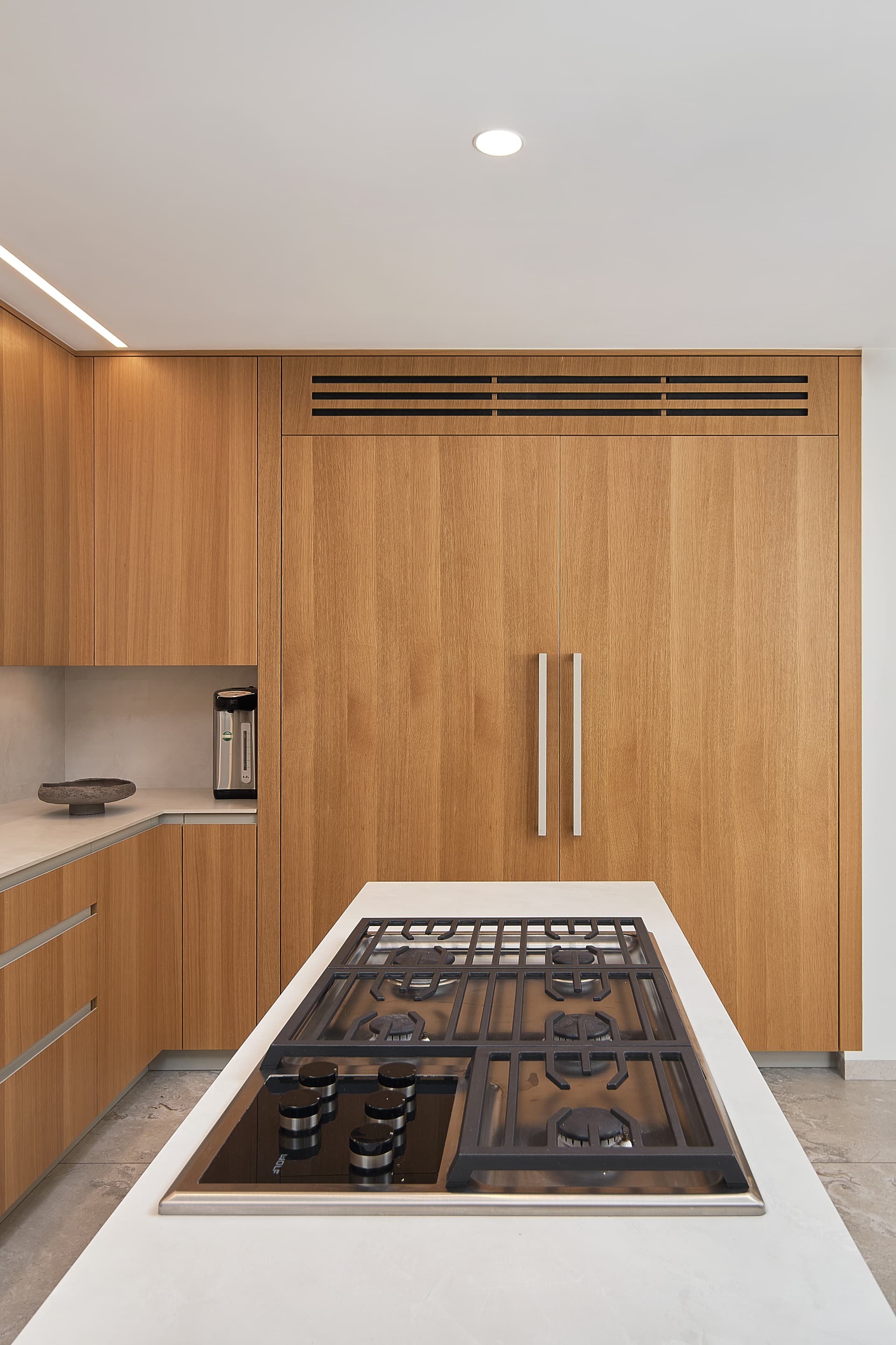 Kitchen island with stone countertop and integrated gas range